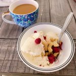 Vanilla I cream in a bowl with nuts and raspberries